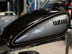 a close up of a black and silver yamaha motorcycle with the words yamaha on it