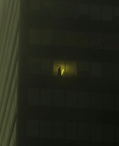 an image of a window in the side of a building that is lit up at night