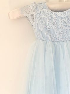 This beautiful dress is perfect for your Spring wedding, or for her special birthday. Beginning with an intricate lace bodice with a layered, light blue tutu skirt. The detail ends with the beautiful v-back. Elegant Blue Princess Dress With Lace Bodice, Light Blue Tutu Dress For Spring Baptism, Blue Lace Princess Dress For Wedding, Blue Tulle Dress With Lace Trim, Fitted Princess Dress With Lace Bodice For Confirmation, Blue Princess Dress With Lace Bodice For Wedding, Blue Lace Bodice Princess Dress For Wedding, Blue Lace Princess Dress For Party, Light Blue Fitted Princess Dress For Wedding