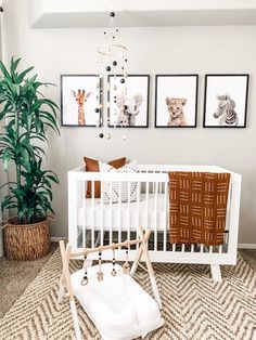 a baby crib with pictures on the wall