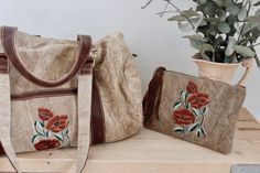 You're going to love our canvas weekender travel sets! Perfect for adventures... a great size to fit in everything you need for a few days away! One large weekend bag and a smaller purse for your important belongings!The weekend bag...- Gorgeous Poppy embroidery - Two choices of straps.. shoulder straps or detachable crossbody strap- Wonderful worn in canvas fabric with genuine leather straps and zip - Two compartments inside to keep small items safe, one with a zip closure. One extra pocket on Cheap Embroidered Travel Satchel, Poppy Embroidery, Sunflower Bag, Canvas Weekender Bag, Embroidered Purse, Floral Purse, Carpet Bag, Boho Purses, Weekend Bag