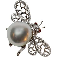 Beautiful Bumble Bee pin, set with approximately 0.50ctw in G/VS diamonds, enhancing the wings and body, a 15mm White South Sea Pearl and two Ruby eyes; 18k white gold; pin measures approx. 40.5mm x 24.25mm and weighs approx. 14.20gm. A Classic and Timeless Beauty! Bee Jewelry, Bee Brooch, Insect Jewelry, Sea Pearl, Ruby Jewelry, Sea Pearls, South Sea Pearls, Ruby Diamond, Pearl Diamond