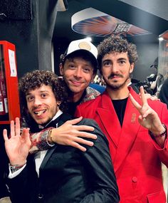 two men in red jackets posing for the camera