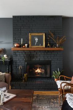 a living room filled with furniture and a fire place in the middle of a fireplace