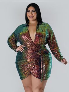 a woman in a green and pink sequin dress with her hands on her hips