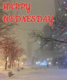 a snowy park with benches and lights in the background that says happy wednesday