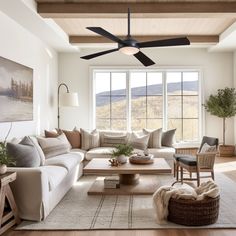 a living room filled with furniture and a ceiling fan