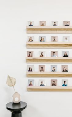 a wall mounted shelf with multiple photos on it