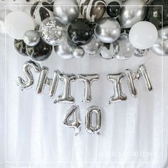 silver and black balloons with the word party 40 on them in front of a white backdrop