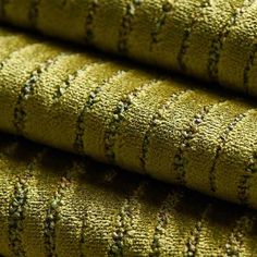 close up view of green fabric with small black dots on the top and bottom part