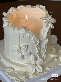 a close up of a cake with a candle in the middle and flowers on it