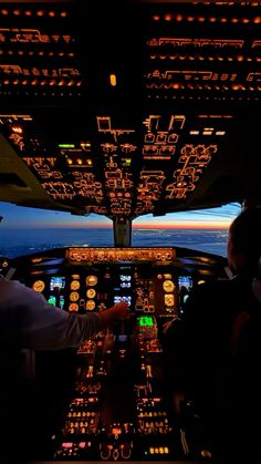 two pilots in the cockpit of an airplane at night