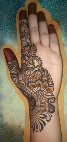 a hand that has a henna on it and is in the shape of a flower