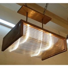 a wooden light fixture hanging from the ceiling