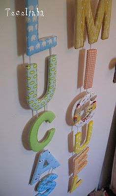 the letters are hanging on the wall next to each other in this child's room