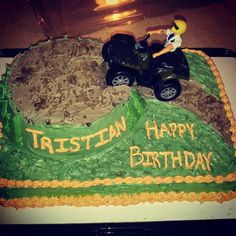 a birthday cake with a toy atv on it