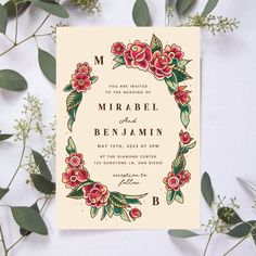 a wedding card with flowers and leaves on it