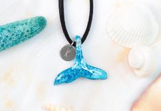 "Beautiful and delicate necklace in the shape of a dolphin tail made of resin and perfect to wear all year round as a sign of your enormous love for sea life, dolphins and whales. This small unisex ocean choker it is light and is available in ten different colors. This piece of jewelry is a real gift for yourself or your loved ones, if you are a surfer or simply love this beautiful animal, this is your pendant. This pretty whale tail is made of resin dyed blue and with a reef effect. Each piece Ocean-inspired Adjustable Charm Necklace Gift, Ocean-inspired Adjustable Necklace As A Gift, Adjustable Ocean-inspired Necklace For Gifts, Adjustable Ocean-inspired Necklace For Gift, Adjustable Ocean-inspired Round Pendant Jewelry, Dolphin Tail, Surfer Jewelry, Dolphin Jewelry, Dolphin Necklace