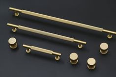 an assortment of brass handles and knobs on a black background with space for text