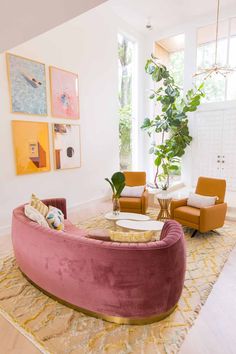 a living room filled with lots of furniture and decor on top of a wooden floor