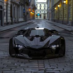 a black sports car is parked on the street