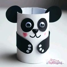 a paper cup with a panda face painted on it's side and the bottom is black and white