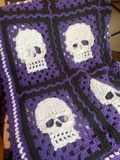 a crocheted blanket with skulls on it