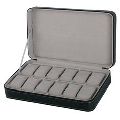 an open black case with twelve compartments for watches and bracelets on white back ground