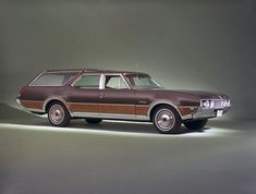 a brown station wagon parked on top of a gray floor