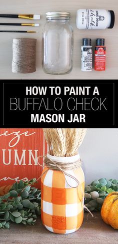 an orange and white mason jar sitting on top of a table next to other items