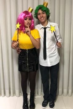 two people dressed in costumes posing for a photo