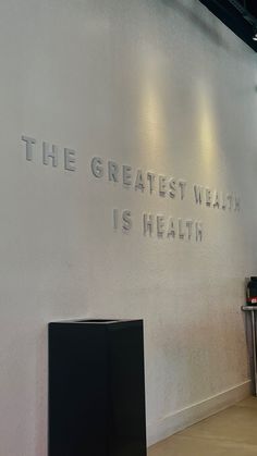 there is a sign that says the greatest health is health on the wall behind it