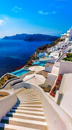 stairs leading down to the water and white buildings