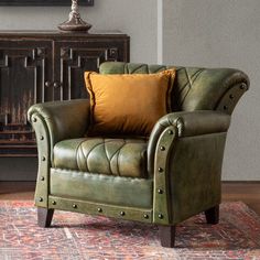 a green leather chair sitting on top of a rug