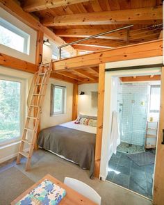 an instagram photo of a bedroom with a ladder to the ceiling and a bathroom in the background