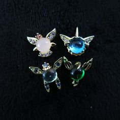 three different types of brooches sitting next to each other on a black surface