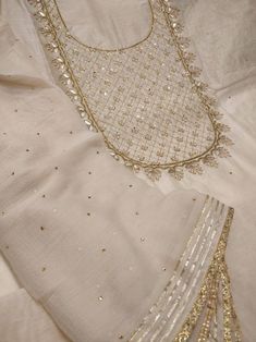 Item Overview Atharva Embroidered Salwar Kameez w/Beautiful Embroidered Neck in Beige Chanderi w/Chiffon Dupatta w/Stones And Gota Patti Border Dno. CH1049 Fabric: * Shirt Chanderi Silk 2.5 Mts, * Dupatta: Pure Chiffon Chinnon 2.5 Mts (W/Gota Work Jaal) * Bottom Santoon 2.5 Mts. Excusive Hand Embroidered Party Wear Punjabi Suit. Customization: * Fabrics: Designs Can be made in different Fabrics. * Stitching Available Care: Dry Clean/ Avoid direct Ironing on Embroidery Part. Reference pictures. C Embroidered Salwar, Gota Work, Kurta Neck Design, Pakistani Fashion Party Wear, Silk Bottoms, Pure Chiffon, Kurti Designs Party Wear, Hand Work Embroidery, Embroidery Neck Designs