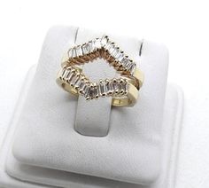 a diamond ring sitting on top of a white box