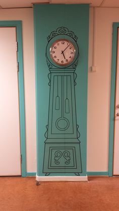 a clock on the side of a wall in an office building with blue walls and doors