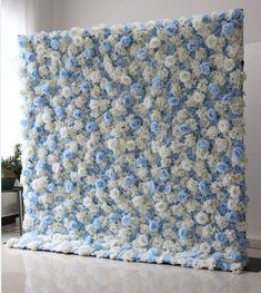 a blue and white crocheted blanket with flowers on it