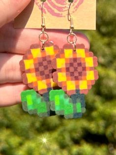 Super cute earrings for the Sunflower in your life! A great gift for anyone who loves this flower-- especially if they love Stardew Valley too <3 Super lightweight and comfortable to wear  Handmade with love using mini perler beads & silver/gold plated jewelry appliances *All ear wires are nickel-free, however jump-rings are not. This means that the part of the appliance that enters your ear will be nickel-free, but the rings attaching it to the charm will not be. This will accommodate moderate Perler Bead Jewelry, Mini Perler Beads, Perler Earrings, Nickel Allergy, The Sunflower, Stardew Valley, Perler Bead, The Rings, Perler Beads