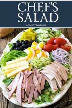 a plate filled with meats and vegetables on top of a wooden table