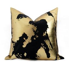 a black and gold pillow on a white background