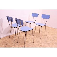 three blue chairs sitting next to each other in a room with cork flooring on the walls