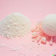 two balls of white powder next to each other on a pink background