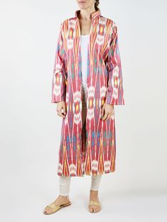 Our classic caftan duster. Inspired by the caftan garments of Uzbek royalty, the Fergana is designed with livable luxury in mind. Slits on the sleeve and the body of the caftan are created to highlight the jewelry and clothing that is worn underneath. Mandarin collar Sleeve and side slits Matching waist tie 100% silk ikat handwoven in Tashkent, Uzbekistan Tailored in Istanbul, Turkey Dry clean only Multicolor Ikat Print Long Sleeve Kaftan, Long Sleeve Multicolor Ikat Print Kaftan, Multicolor Long Sleeve Ikat Print Kaftan, Multicolor Long Sleeve Kaftan For Daywear, Festive Long Kaftan, Fitted Red Long Sleeve Kaftan, Bohemian Fitted Long Thobe, Fitted Long Bohemian Thobe, Traditional Fitted Kaftan With Kimono Sleeves