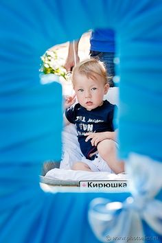 a baby is sitting in a blue chair