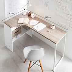 a desk with a chair next to it and an open book on the table top