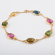 This is a classic style bracelet. A must-have statement piece for every woman. It's a classic luxury to have. A perfect gift for your loved ones. -Material - 18K Solid Yellow Gold -Gemstone - Multi-Color Tourmaline -Gross weight - 5.0 grams The bracelet length can be adjusted to your wrist size, on request. You can also go to my shop Home for more similar bracelets: https://www.etsy.com/in-en/shop/SilverAppeal FEEDBACK Please Leave A Positive Feedback Along With A 5 Star Rating On Your Purchase. Yellow Bracelet, Solid Gold Bracelet, 18k Gold Bracelet, Arm Bracelets, Bracelet Minimalist, Gems Bracelet, Gold Armband, Tourmaline Bracelet, Birthstone Bracelet