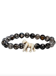 a black and white beaded bracelet with an elephant charm on it's side